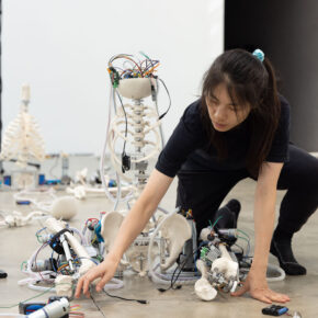 Person interacting with robotic components.
