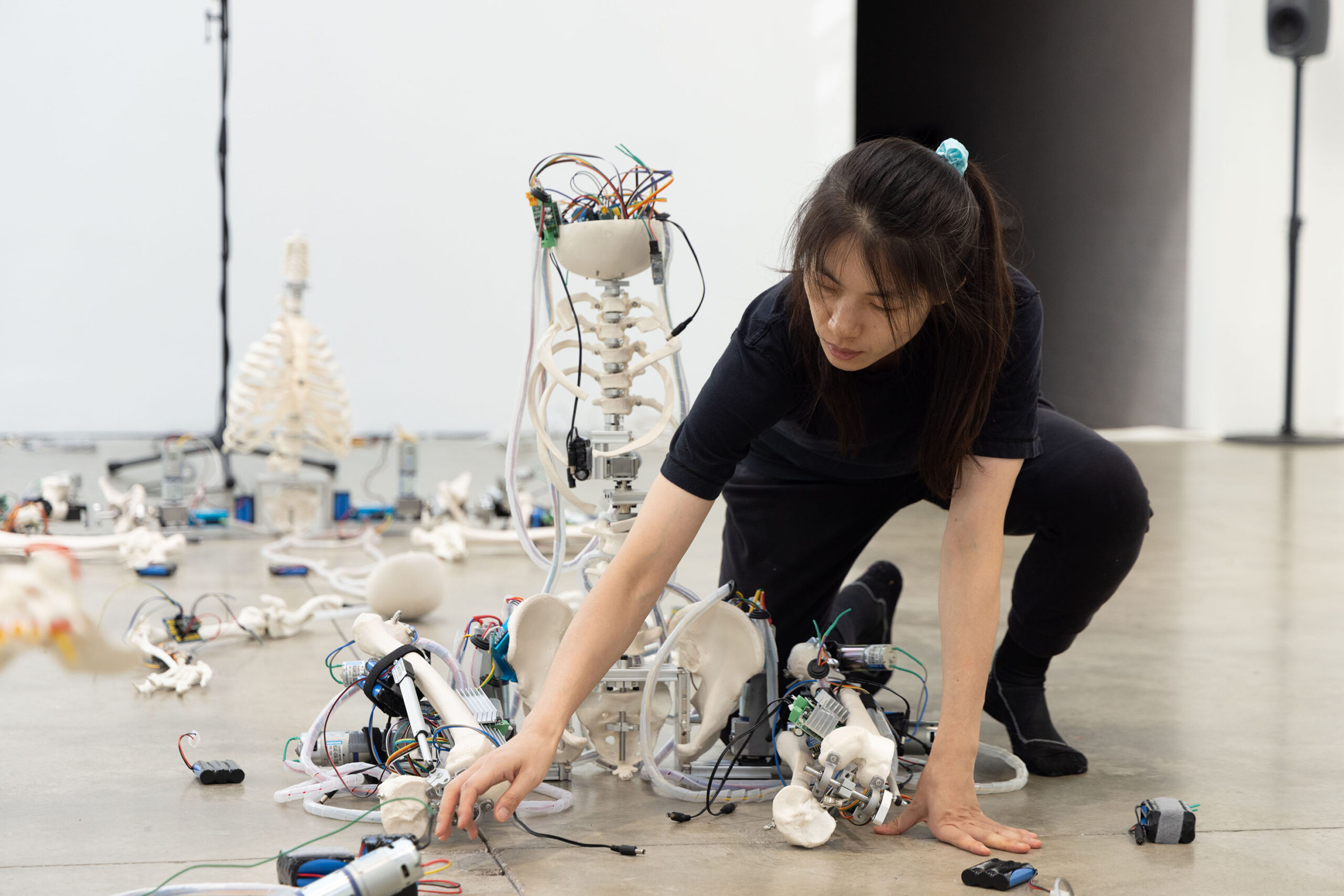 Person interacting with robotic components.